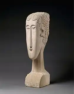 Cap de femeie; de Amedeo Modigliani; 1912; calcar; înălțime: 68,3&nbsp;cm, lățime: 15,9&nbsp;cm, adâncime: 24,1&nbsp;cm; Muzeul Metropolitan de Artă (New York City)