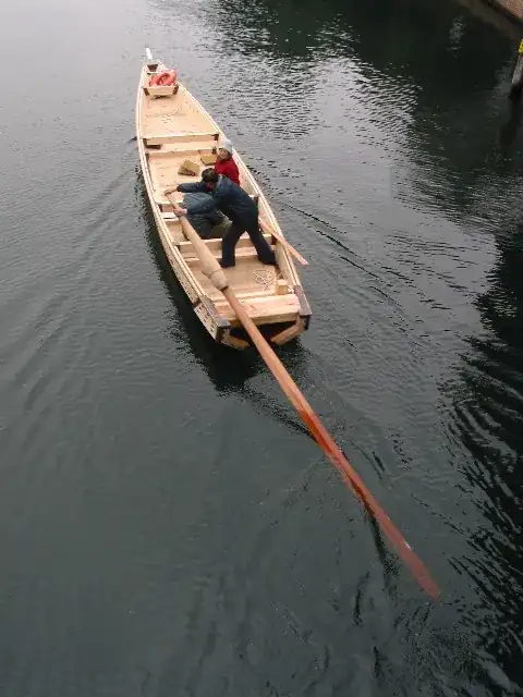 single oar sculling water taxi
