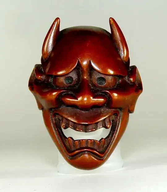 A masklike carving of a demon face